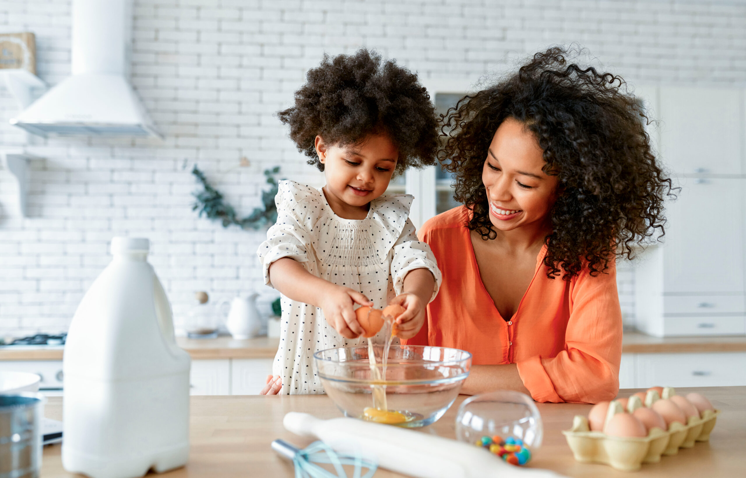 A mother and daughter baking together.